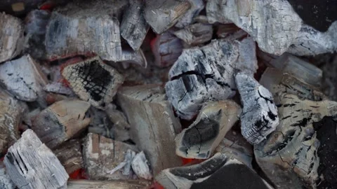 Grill preparation concept. close-up of hot coals on the grill during the day. Stock Footage 142363391