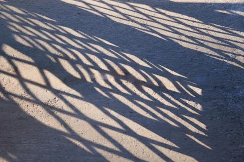 Grill Shadow on pavement Stock Photos
