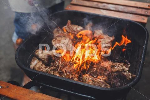 Grill steaks on metal grate with flame, barbecue Stock Photos