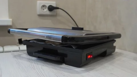 Grill on the table in a kitchen cooking meat Video stock 232944328