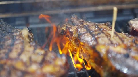 A grill with three pieces of meat on it Stock Footage 301517860