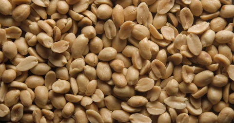 Grilled and salted peanuts close up studio shot over rotating Video stock 334256929