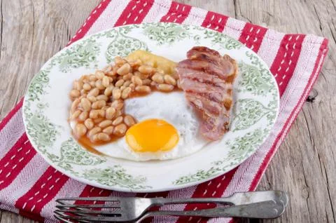 Grilled bacon, beans and fried egg Stock Photos
