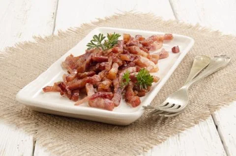 Grilled bacon bits on a plate Stock Photos