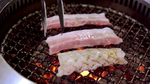 Grilled bacon strips capture essence of sizzling goodness, ready to be devoured. 스톡 동영상 334643447