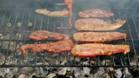 Grilled bacon strips capture essence of sizzling goodness, ready to be devoured. 스톡 동영상 334643517