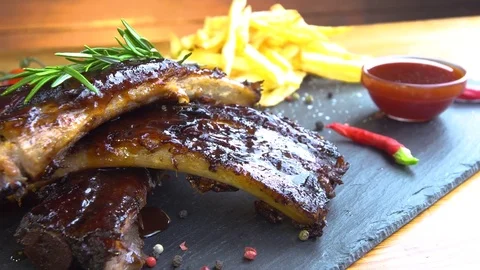 Grilled bbq ribs on stone plate Stock Footage 83537409