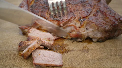 Grilled beef is cut into pieces. Fried meat in close-up. Stock Footage 264161667