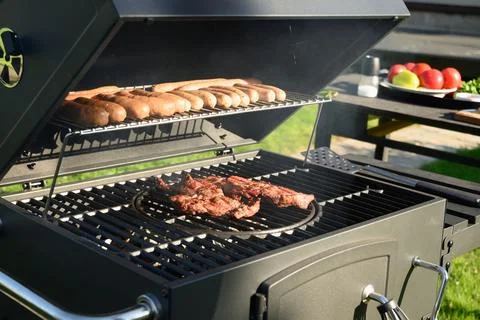 Grilled beef meat outside. BBQ grill. Barbecue party. Stock Photos