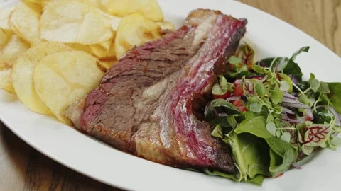 Grilled beef with potato chips and salad Stock Footage 302088151