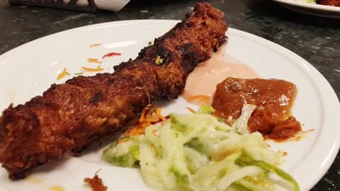 Grilled beef shik kabab served with fresh garden salad arrangement Stock Footage 320635953