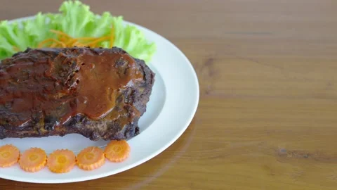 Grilled beef steak covered in thick savory brown gravy sauce served on a wh.. Stock Footage 333051496