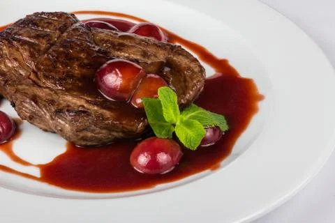 Grilled beef steak with plums Stock Photos
