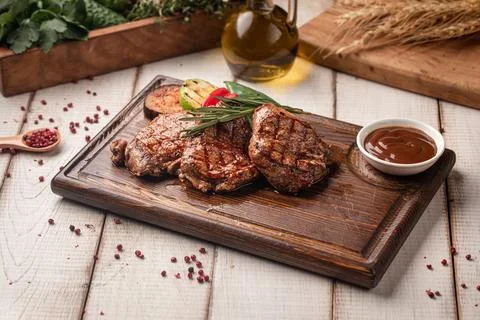 Grilled beef steak portion with vegetables Stock Photos