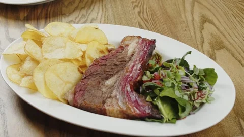Grilled beef steak with potato chips and salad Stock Footage 302088023