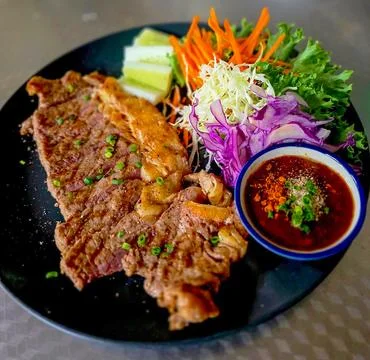 Grilled Beef Steak Served with Fresh Salad and Spicy Dipping Sauce Stock Photos