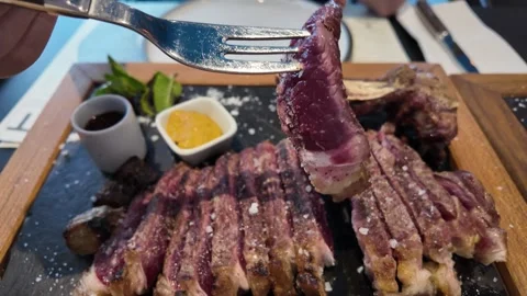 A grilled beef steak sliced on a tray in a restaurant. Stock Footage 317632908