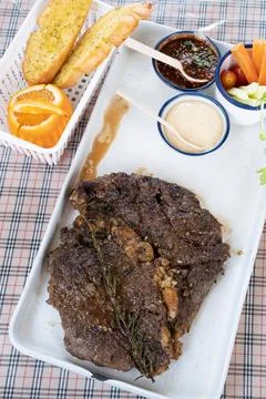 Grilled beef steaks with cream source on white plate Stock Photos