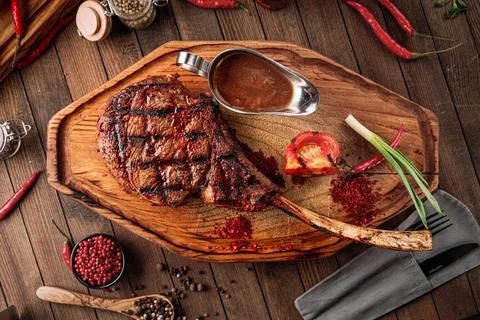 Grilled beef tomahawk steak with pepper sauce Stock Photos