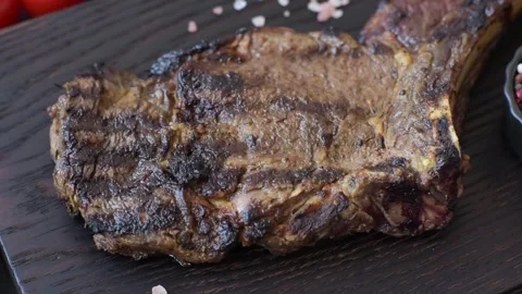 Grilled beef Tomahawk steak seasoned with salt and spices. Tomahawk steak Video stock 344800039