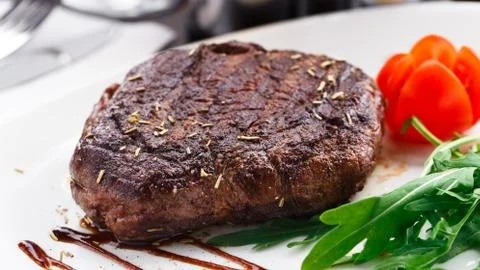Grilled beefsteak on a plate Stock Photos