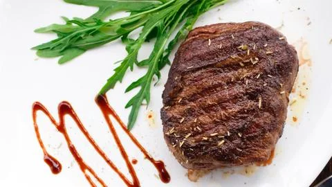 Grilled beefsteak on a plate Stock Photos