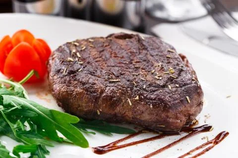 Grilled beefsteak on a plate Stock Photos