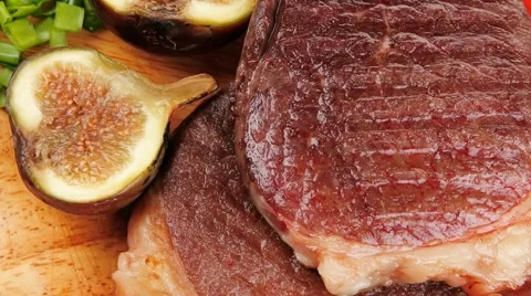 Grilled beefsteak served with hot cayenne peppers green stuff Stock Footage
