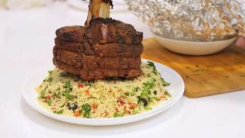 Grilled bone-in beef carefully placed on plate with garnish. Juicy meat Stock-Footage 275887027