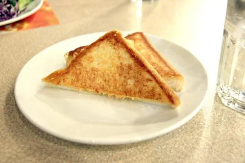 Grilled bread is in dish. Stock Photos