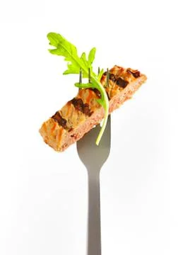 Grilled bread slice with green sprout on fork Stock Photos