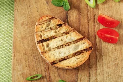 Grilled bread slice with tomatoes and herbs Stock Photos