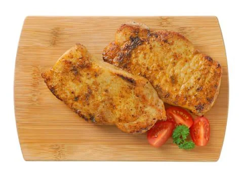 Grilled bread slices with cherry tomatoes on wood board Stock Photos