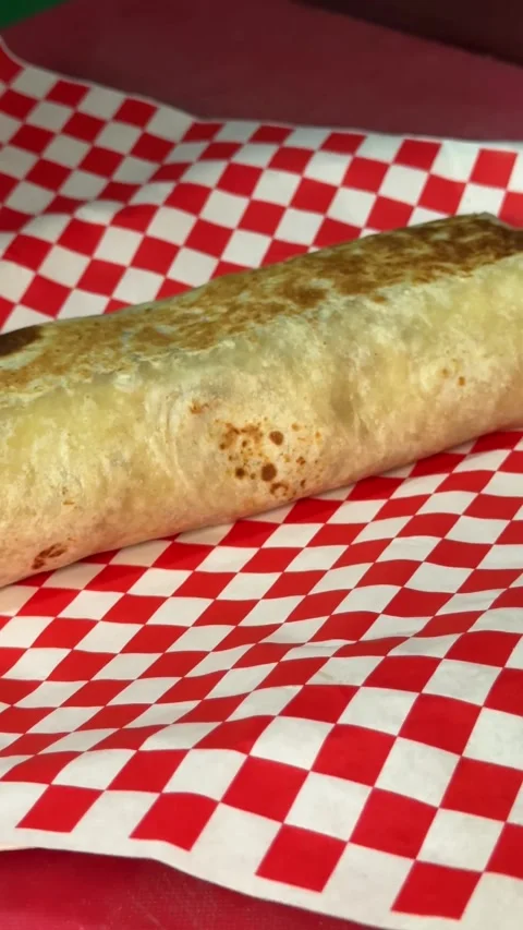 Grilled Burrito on Red Checkered Sheet Stock Footage 318749335