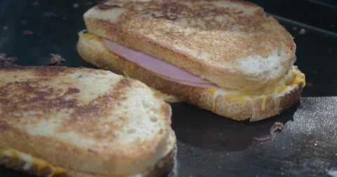 Grilled cheese melting on flat top grill outside Stock Footage 282765611