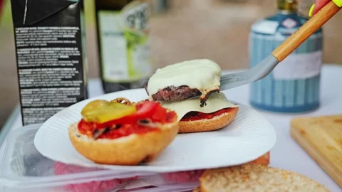 Grilled Cheeseburger Freshly Cooked Over Gas Flame at Nature Camp Spot Stock Footage 315077456
