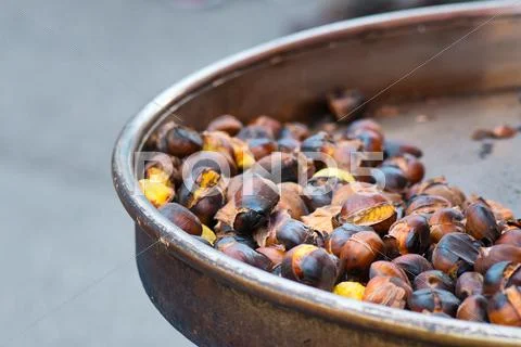 Grilled chestnuts for sale in a market stall Stock Photos