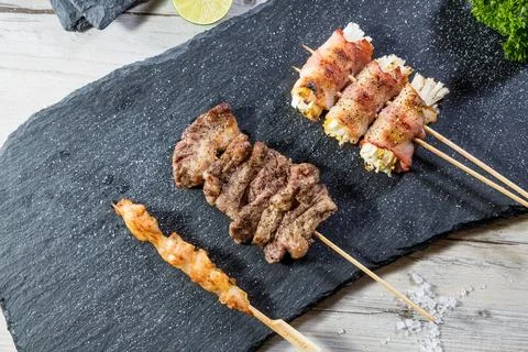 Grilled chicken beef bacon enoki mushroom skewer platter Stock Photos
