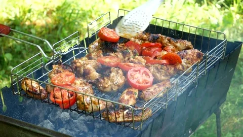 Grilled chicken being placed on a white plate Fried chicken meats on an open air Stock Footage 238773466