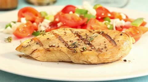 Grilled chicken breast being served with a light sauce Stock Footage 24672038