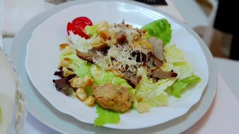 Grilled chicken caesar salad presenting crispy croutons, grated parmesan, ripe Stock Footage 331463678