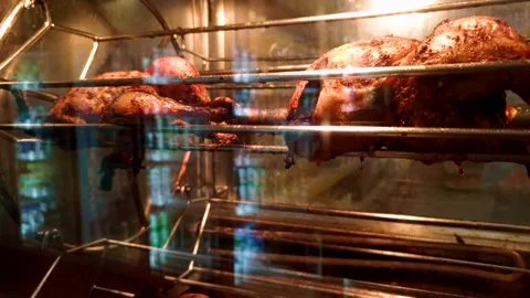 Grilled chicken. Chicken is cooked on a spit in the oven. Smooth rotation of the Stock Footage 304880209