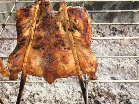 Grilled chicken cooked on bbq grid Stock Photos