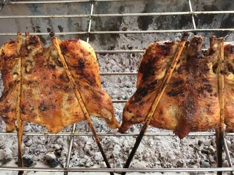 Grilled chicken cooked on bbq grid Stock Photos