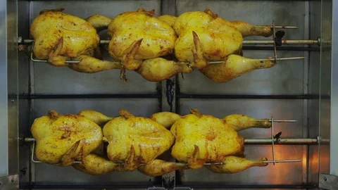 Grilled chicken cooked on a spit Stockbeeldmateriaal 98252046