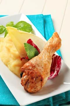 Grilled chicken drumstick with mashed potatoes and veggies Stock Photos