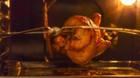 Grilled chicken in the oven on a spit Stock Photos