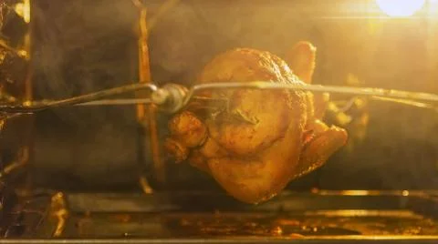 Grilled chicken in the oven on a spit Stock Photos