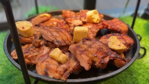 Grilled chicken pieces with charred texture and butter slices Stock Footage 314708141