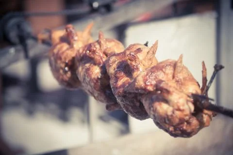 Grilled chicken on rotating machine Stock Photos